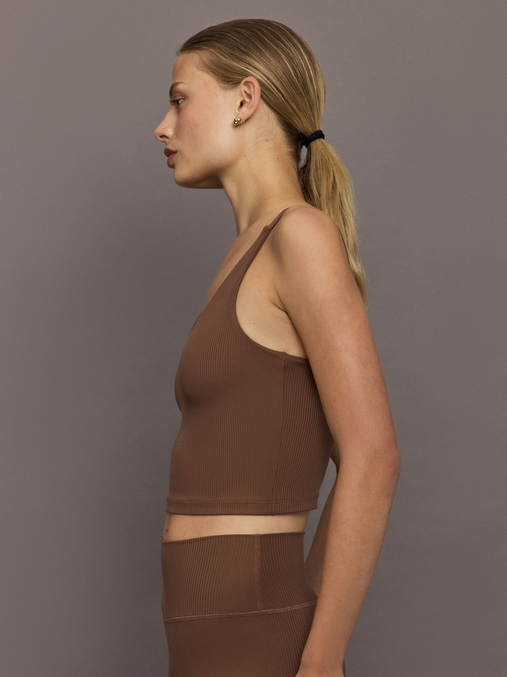 Side profile of cocoa brown ribbed melt v-neck cropped tank top, women’s fitted activewear tank with ribbed texture.