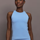 Model is wearing Racer High Neck Active Tank in Serenity, front view.