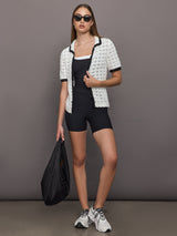 Model wears double-layered melt tank with black outer body and white inner layer.