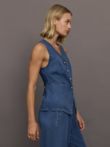 Model wears medium wash vest with a button-down front and sleeveless design.