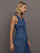 Model wears medium wash vest with a button-down front and sleeveless design.