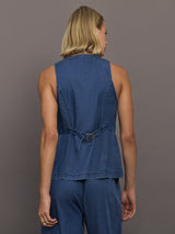 Model wears medium wash vest with a button-down front and sleeveless design.