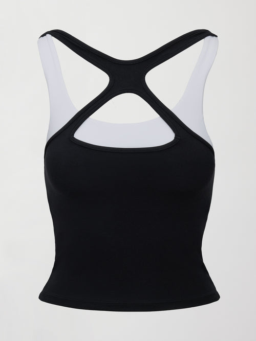 Model wearing a black and white colorblock tank top.
