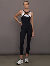 Model wearing a black and white colorblock tank top.
