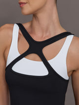 Model wearing a black and white colorblock tank top.
