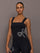 Model wearing Rhinestone Bow Tank in Melt Black, front view with rhinestone bow detail at side.