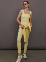 Model is wearing Melt Rib High Rise Legging in Banana, styled with Square Neck Tank.