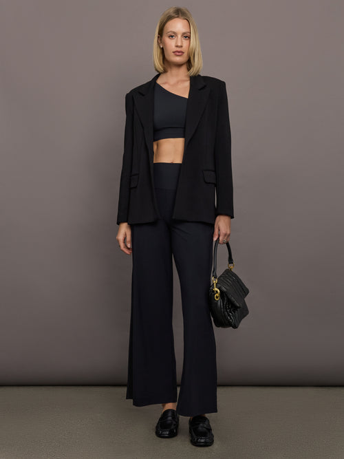 Model is wearing Melt One-Shoulder Cropped Tank in Black, full body styled look.