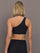Model is wearing Melt One-Shoulder Cropped Tank in Black, back view.
