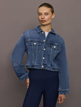 Model wearing Crop Denim Jacket with Jewel Buttons in Dark Wash, front view.