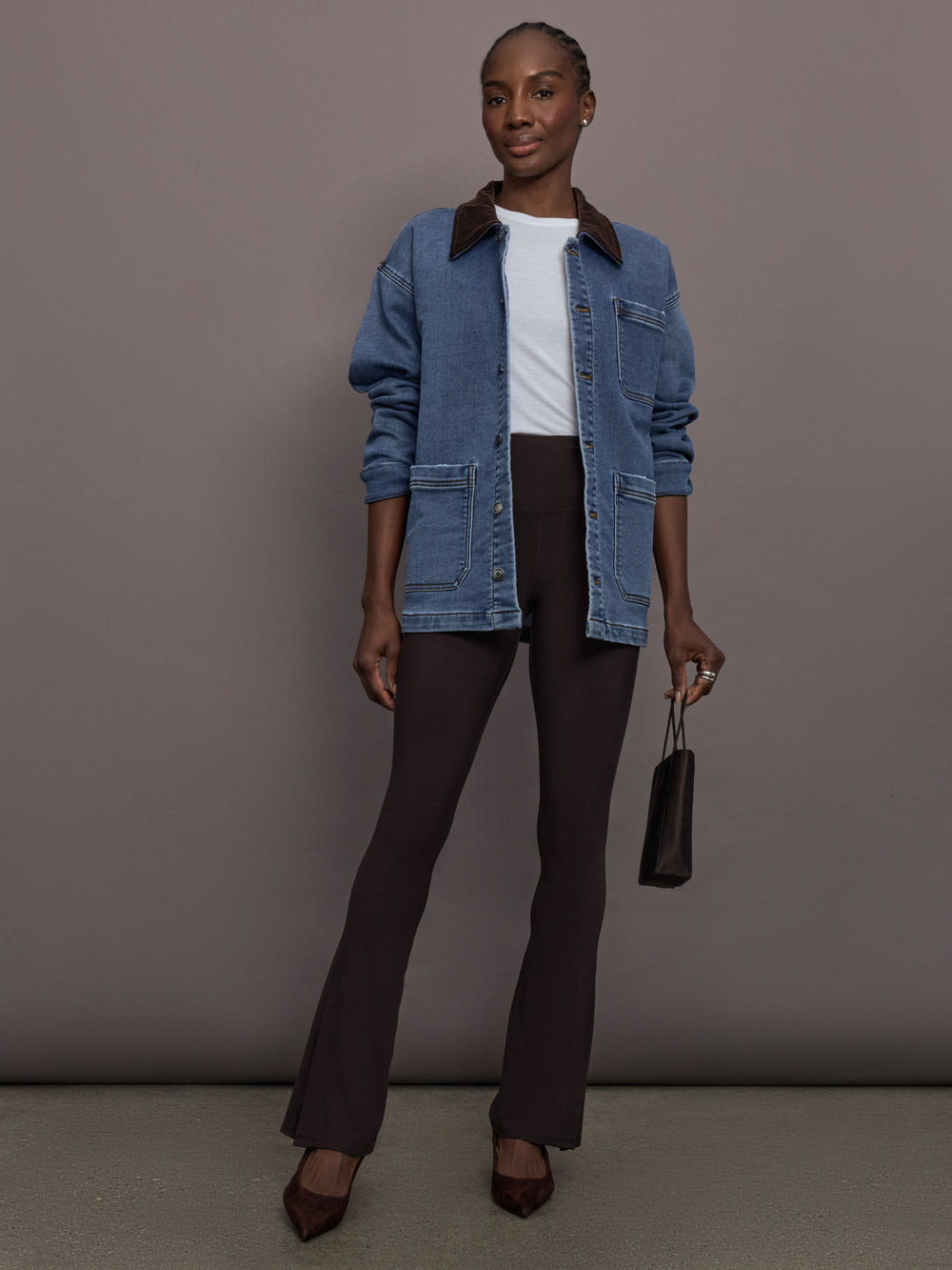Model is wearing the Denim Barn Jacket in Dark Wash, full body view.
