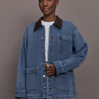 Model is wearing the Denim Barn Jacket in Dark Wash, front view.