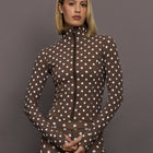 Model is wearing the Melt Full Zip Active Jacket in Carafe White Polka Dot, front view.