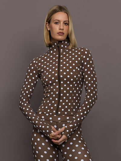 Model is wearing the Melt Full Zip Active Jacket in Carafe White Polka Dot, front view.