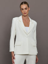 Model wearing an Ivory single breasted blazer.