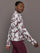 Model wears a burgundy toile printed mock neck zip up long sleeve track sweatshirt.