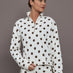 Model is wearing the Polka Dot Half Zip in white with carafe polka dot print shown from the front with cropped relaxed fit.