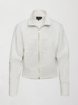 Model wears ivory Interlock Full Zip Jacket featuring a sleek, minimalist design with a high collar and full-length zipper.