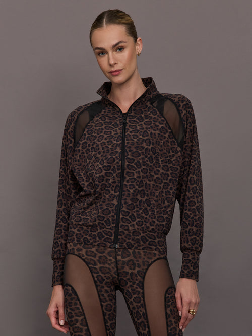 Model wearing a leopard print jacket with sheer panels.