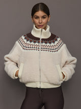 Model wearing Fairisle Sherpa Jacket in natural nude sherpa with multicolor Fairisle knit yoke and zip front, front view.