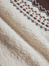 Detailed fabric shot of Fairisle Sherpa Jacket in natural showing soft sherpa fleece and multicolor knit fairisle pattern.
