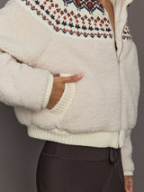 Close-up of Fairisle Sherpa Jacket in nude sherpa with textured fleece and multicolor knit pattern.
