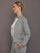 Model is wearing a heather grey Ultrasoft Bomber Jacket with gold zipper and front pocket detail, side view.