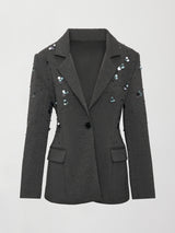 Flat lay of grey embellished blazer with sequins and front button closure.