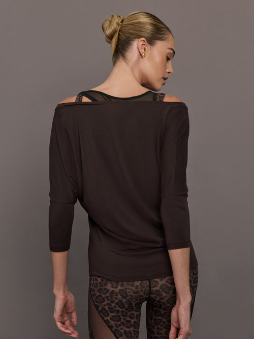 Back view of model wearing Long Sleeve Off Shoulder Tee Chocolate Torte with exposed shoulder detail.