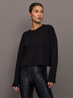 Model wearing French Terry Crew Neck Sweatshirt in Black, front view.