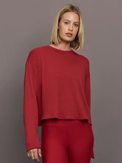 Model is wearing French Terry Cropped Crew Sweatshirt in Cherry Red, front view.