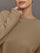Close-up of Crew Neck Sweatshirt in French Terry Chinchilla raw edge detail at sleeve and neckline.