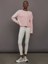 Full body view of women’s lotus French Terry crew neck sweatshirt styled with white leopard leggings.