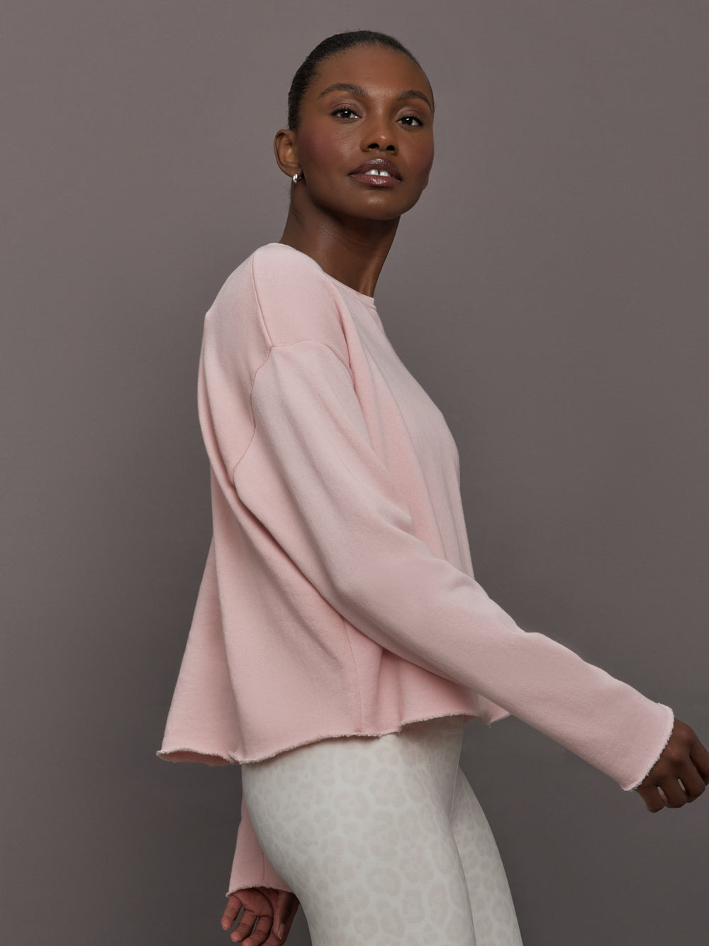 Side view of women’s lotus French Terry crew neck sweatshirt on model.