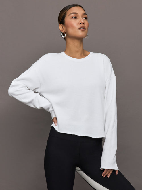 Close-up of cropped fit on model wearing French Terry Crew Neck Sweatshirt in White.