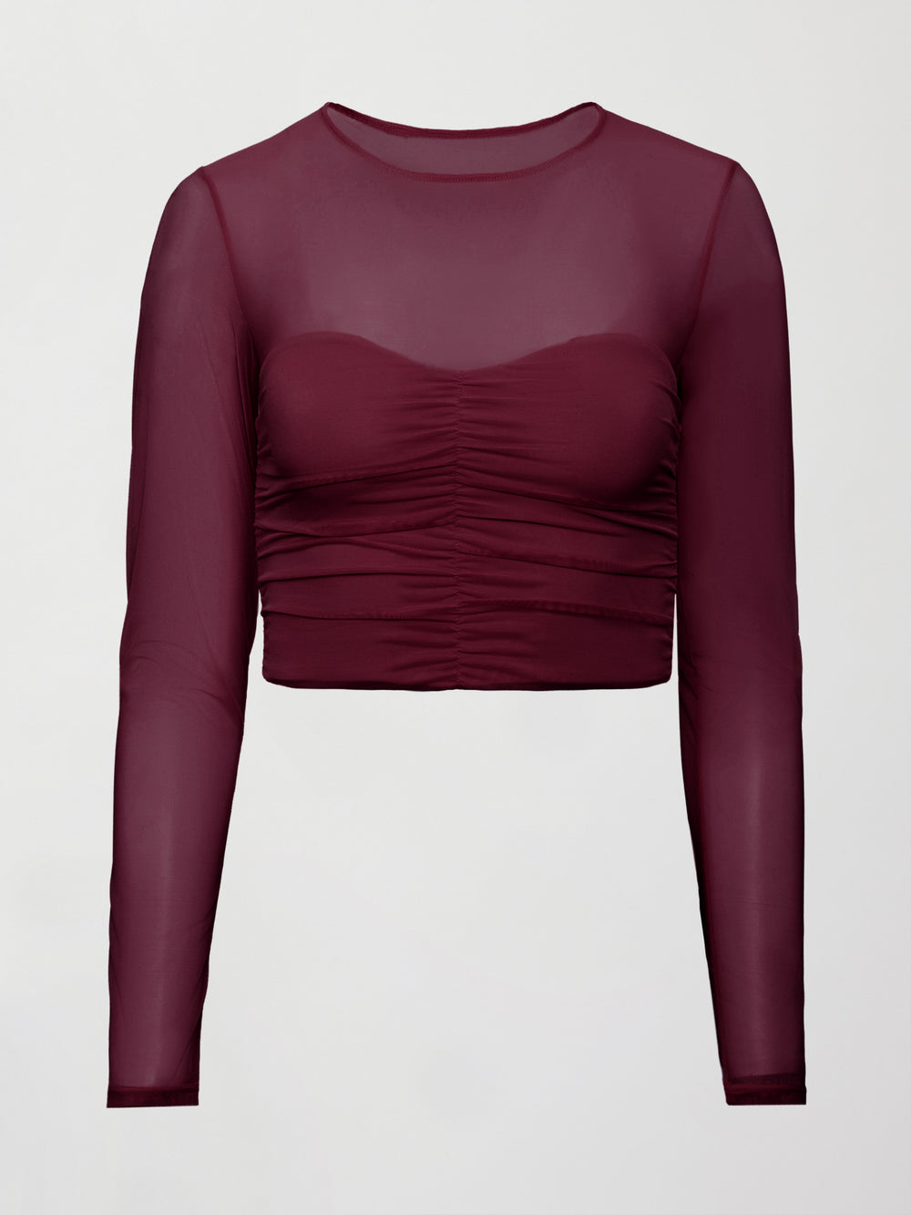 Model wearing a burgundy long sleeve top with sheer sleeves