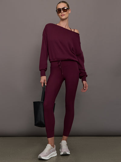 Model wearing off should sweatshirt in color fig