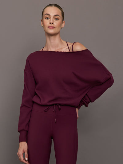 Model wearing off should sweatshirt in color fig