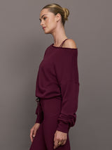 Model wearing off should sweatshirt in color fig