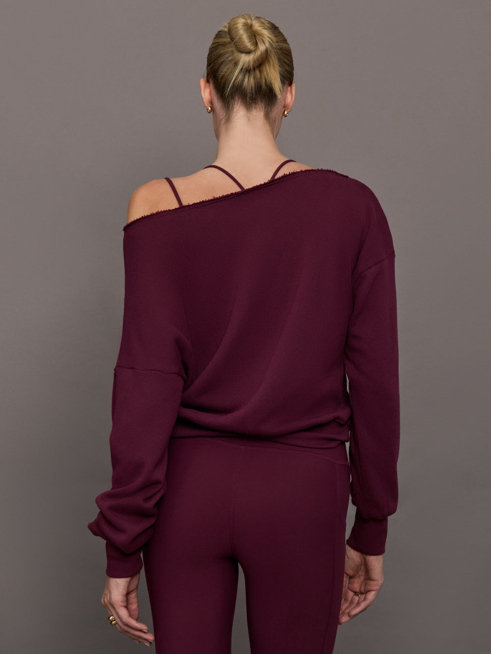 Model wearing off should sweatshirt in color fig