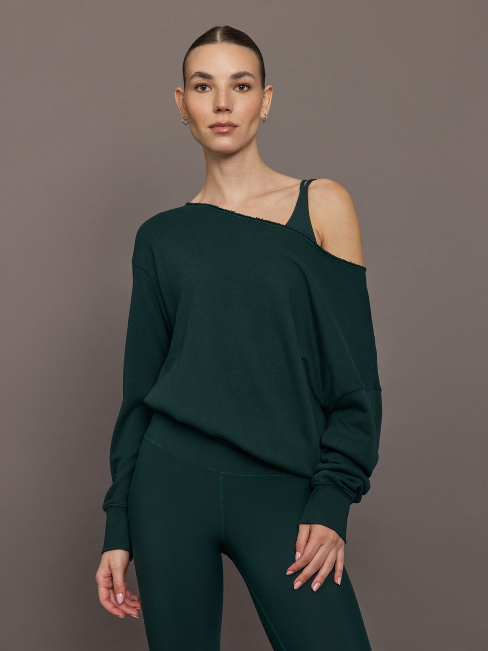 Model is wearing the Off Shoulder Sweatshirt in Forest, front view.