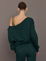 Model is wearing the Off Shoulder Sweatshirt in Forest, back view.