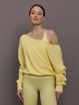 Model is wearing the French Terry Off-Shoulder Sweatshirt in Banana, front view.