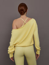 Model is wearing the French Terry Off-Shoulder Sweatshirt in Banana, back view highlighting the wide neckline.