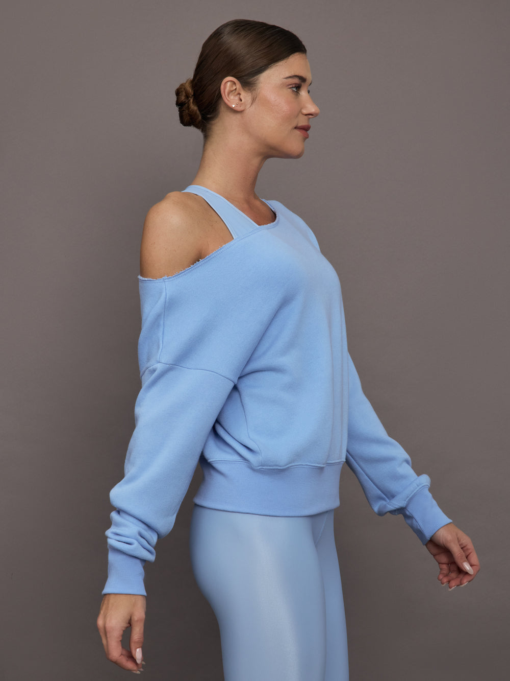 Model is wearing the Off Shoulder Sweatshirt in French Terry in Serenity shown from the side highlighting relaxed fit.