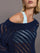 Model wears a navy off shoulder mesh cardigan with diagonal pattern.  