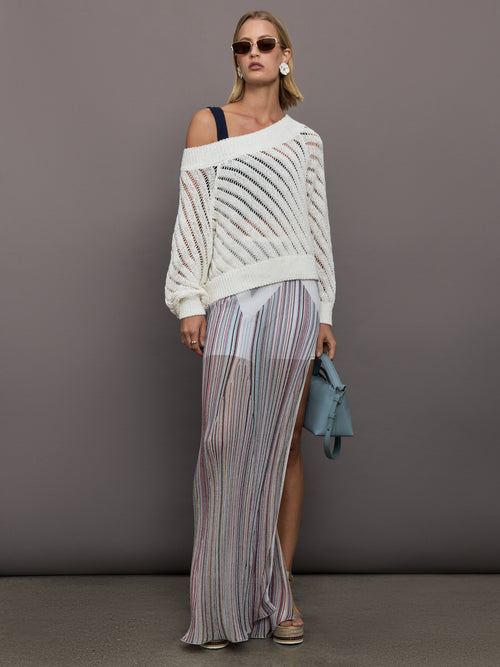 Model wears a white off shoulder mesh cardigan with diagonal pattern.  