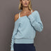 Model wears a light blue off shoulder french terry sweatshirt. 