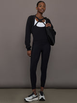 Model wearing fleece black long sleeve shrug.