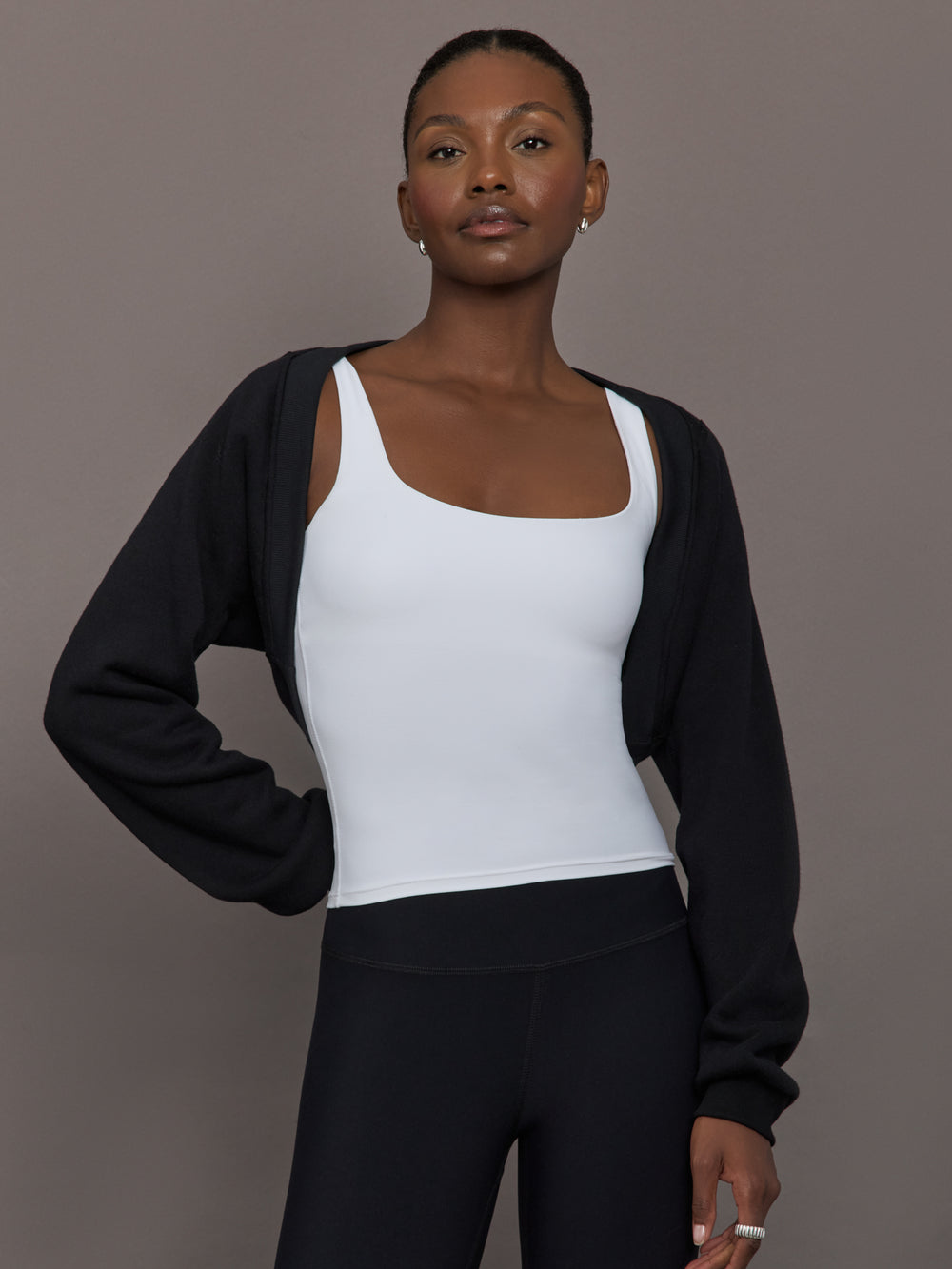 Model wearing fleece black long sleeve shrug.